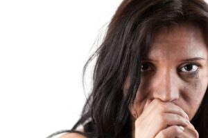 A woman covers her mouth with her hands